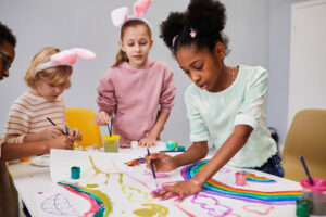 Quiet child observing a group activity in an afterschool program