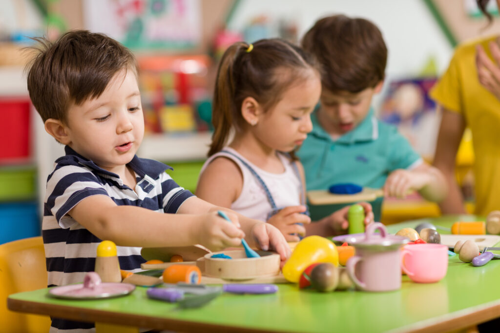 Childs are playing with play clay in preschool classroom